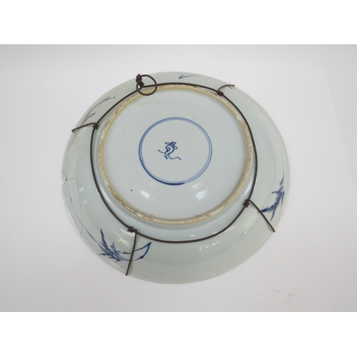 6008 - A 19th Century Chinese blue and white bowl, damage present, with conch shell mark to back, 35cm diam... 