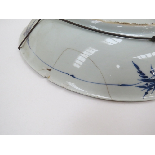 6008 - A 19th Century Chinese blue and white bowl, damage present, with conch shell mark to back, 35cm diam... 