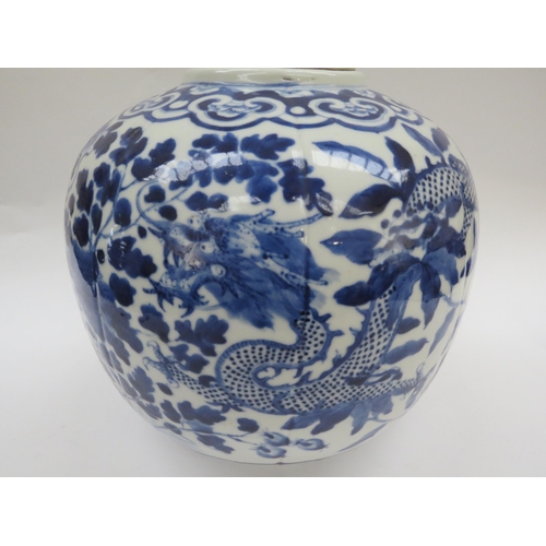 6009 - A Chinese blue and white lidded bulbous jar with double dragon detail with four claws, blue four cha... 