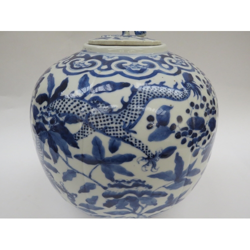 6009 - A Chinese blue and white lidded bulbous jar with double dragon detail with four claws, blue four cha... 