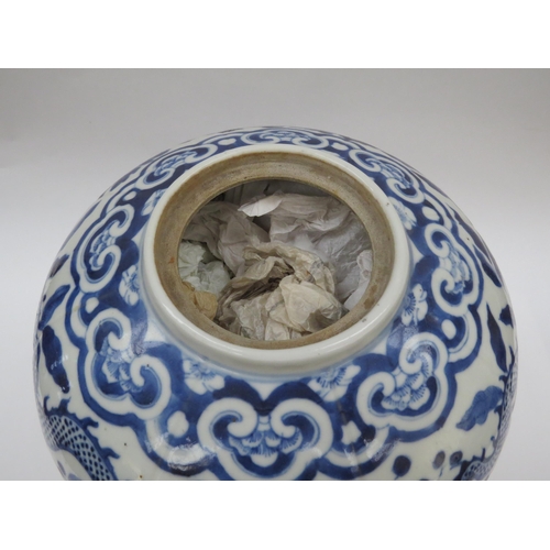 6009 - A Chinese blue and white lidded bulbous jar with double dragon detail with four claws, blue four cha... 