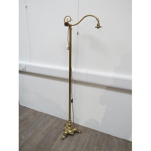 6050 - A gilt brass floorstanding reading lamp, scrolled arm, shaped base, no shade