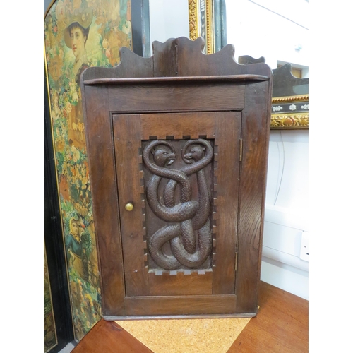 6071 - A late Victorian oak corner cupboard with carved mythical beast panel door, shelf to interior, 78cm ... 