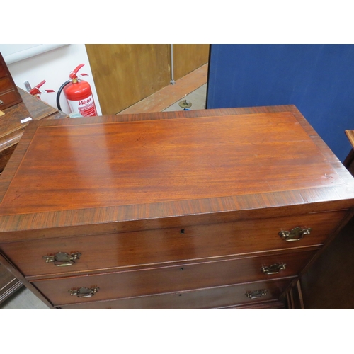 6082 - A 19th Century mahogany chest of three graduating long drawers with rosewood crossbanding over brack... 