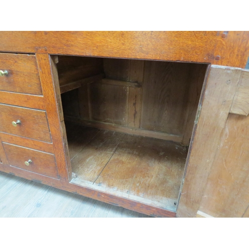 6091 - A Georgian country house oak dresser, the open plate rack top over a six drawer and two door cupboar... 