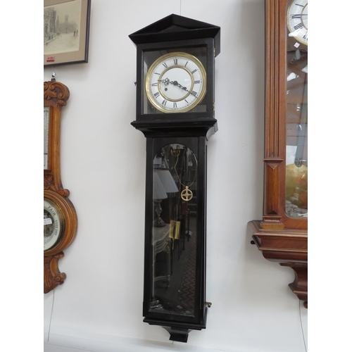 6095 - A wall hanging clock with two train movement striking on gong, with weights, pendulum and key, 112cm... 