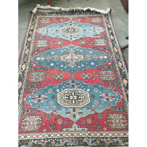 2257 - A blue and red hand-woven Arabic rug 187 x 283cm