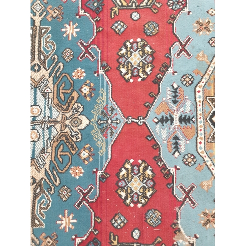 2257 - A blue and red hand-woven Arabic rug 187 x 283cm