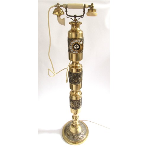 2006 - A 1970's Majesty column telephone in brassed metal with Eastern motifs in relief. 106cm high