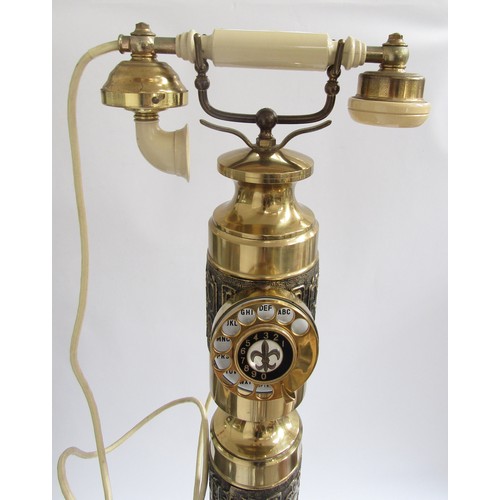 2006 - A 1970's Majesty column telephone in brassed metal with Eastern motifs in relief. 106cm high