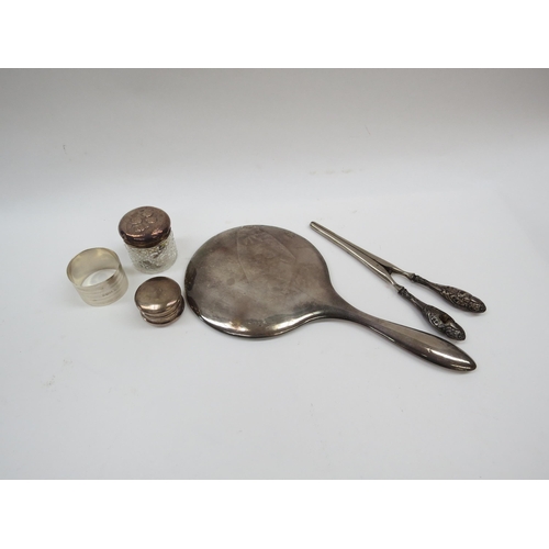 6329 - A silver backed mirror, glove stretchers, lidded pot napkin ring and containers (5)