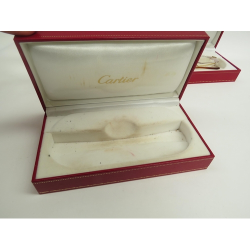 6363 - CARTIER, a pair of titanium 135 framed glasses and three Cartier glasses cases with a pair of Henrik... 