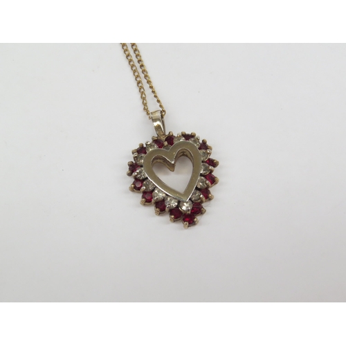 6413 - A 12ct gold chain hung with a heart form pendant