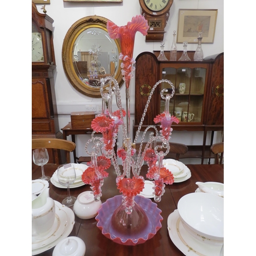 6263 - A highly ornate glass epergne, ten red/pink glass trumpets with frilled edges, nine of which hung on... 