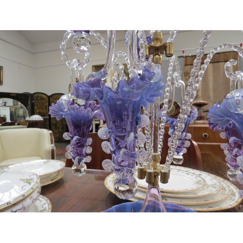 6267 - A highly ornate glass epergne, ten purple/mauve glass trumpets with frilled edges, nine of which hun... 