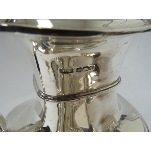 6386 - A silver matched four piece tea set with melon fluting, inscription to water jug, 1488g approx