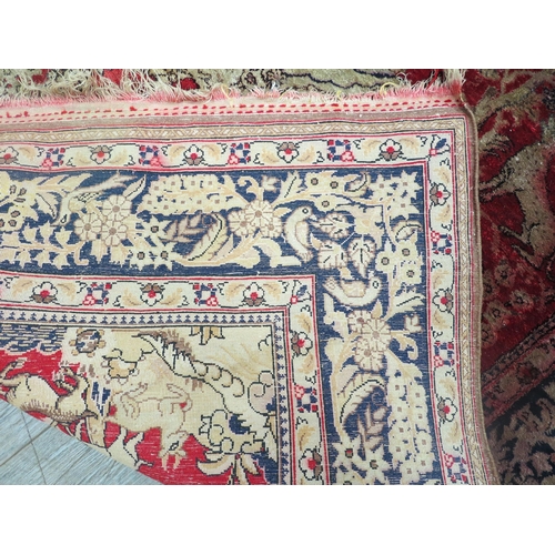 6466 - A red Persian rug with central figural motif surrounded by images of animals and birds in tree, mult... 