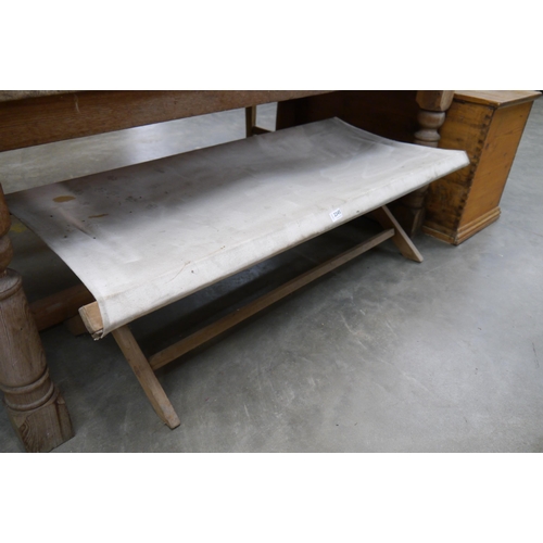 2300 - A pine folding bench with material seat