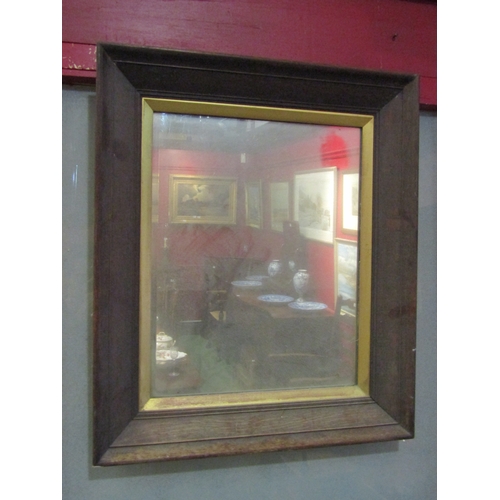 4018 - An early 20th Century oak framed wall mirror with gilt mount, 68cm x 58cm