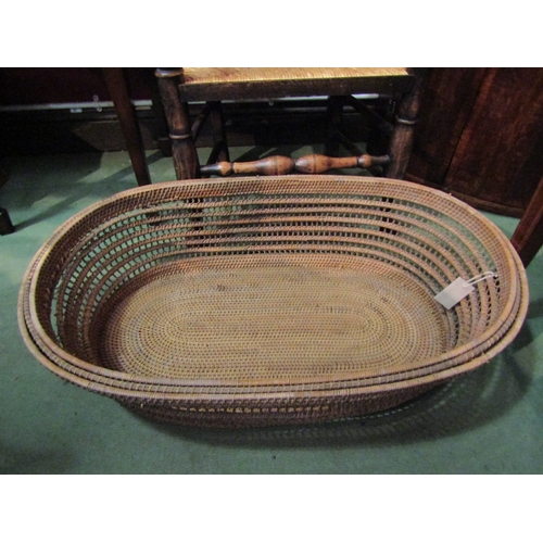 4043 - A woven rush 'Moses' basket, 93cm long