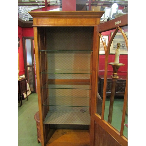 4096 - An Edwardian satinwood display cabinet with crossbanded decoration, the cathedral arch astragal glaz... 