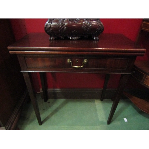 4116 - A George III mahogany fold-over hinged top side/tea table of small proportions, the single frieze dr... 