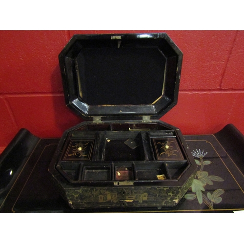 4140 - An Oriental black lacquered octagonal box with gilded decoration. Approximately 33cm x 24cm. Key mis... 