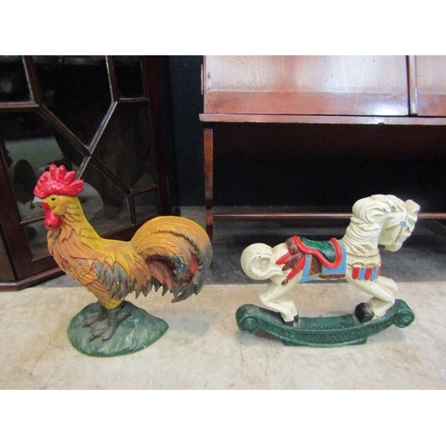 4150 - Two metal doorstops in the forms of a rocking horse and a chicken