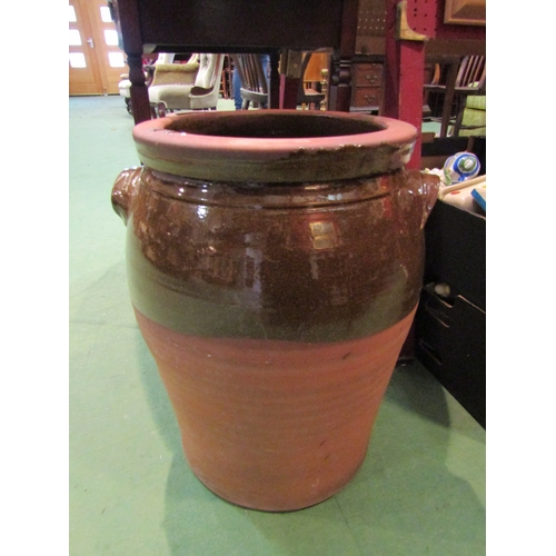 4177 - Two graduated terracotta and brown-glazed jars, largest 48cm tall