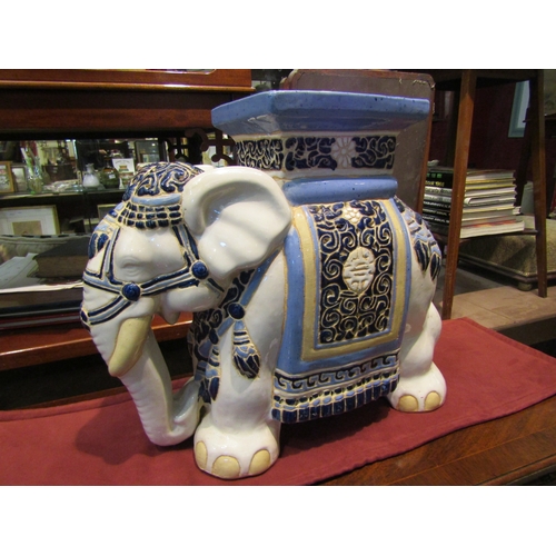 4214 - A ceramic elephant jardiniere stand, 42cm tall