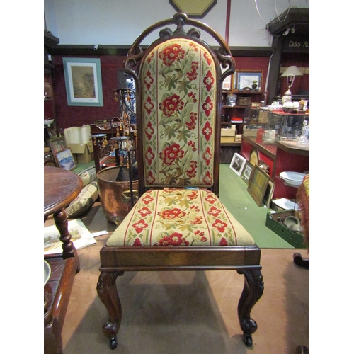 4219 - A circa 1830 rosewood hall chair with carved backrest, the needlepoint upholstery over carved cabrio... 