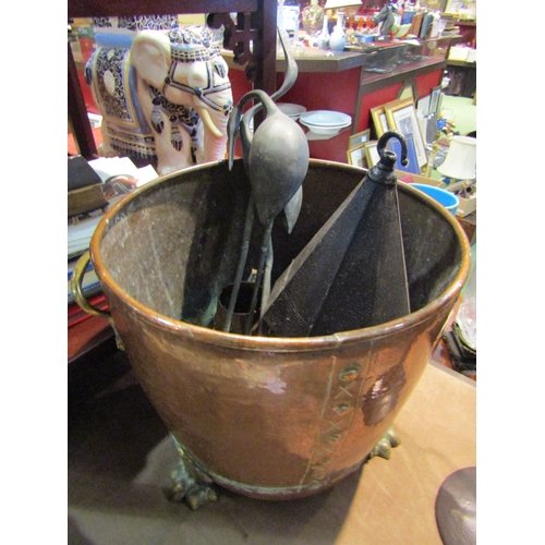 4226 - A 19th Century riveted copper log bucket with lion paw feet, together with contents including a colo... 