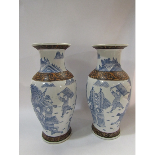 4275 - A pair of 20th Century Oriental blue and white ceramic vases, depicting warriors in battle with band... 