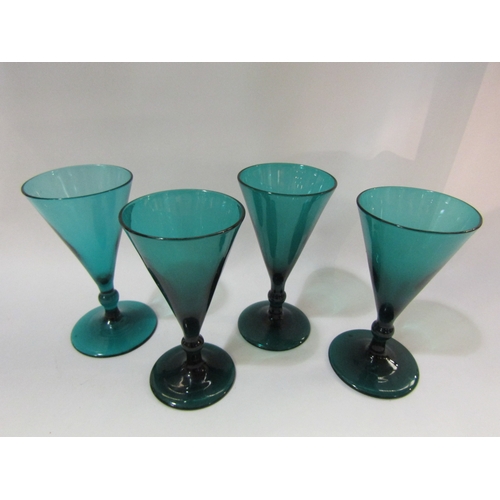 4276 - A set of four conical green wine glasses, rough pontil to underside of base