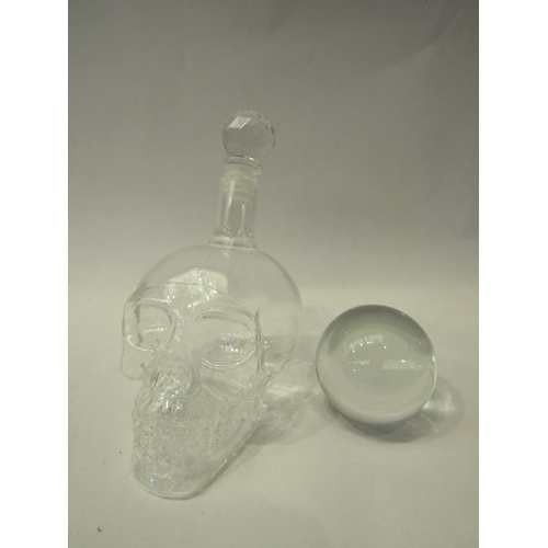 4297 - A boxed skull glass decanter and a crystal ball