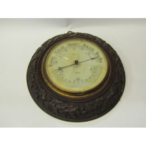 4311 - A carved oak framed wall barometer together with a brass carriage clock (both a/f)