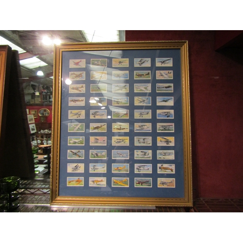 4387 - A framed and glazed collection of aviation related John Player & Sons cigarette cards depicting 