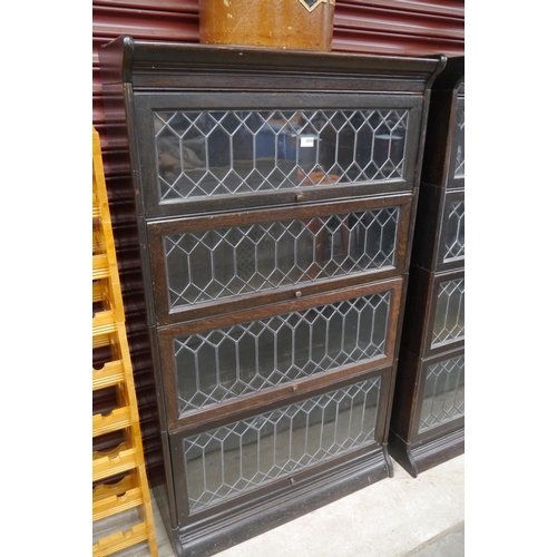 2090 - A Victorian oak four tier lead glazed globe sectional bookcase