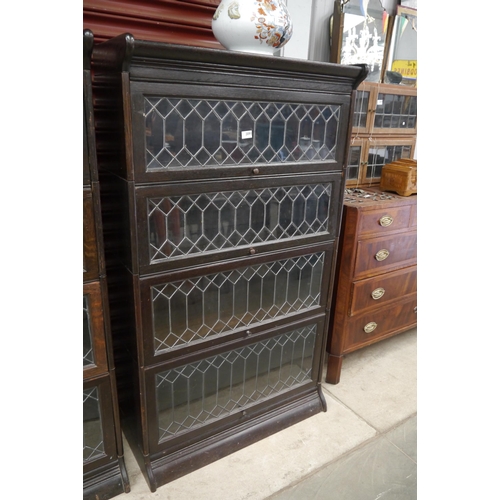 2091 - A Victorian oak four tier lead glazed globe sectional bookcase