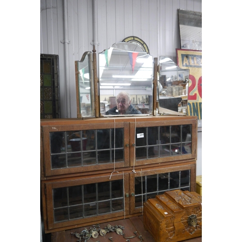 2097 - Two sections of oak and lead glazed stacking bookcases and a triple mirror (3)