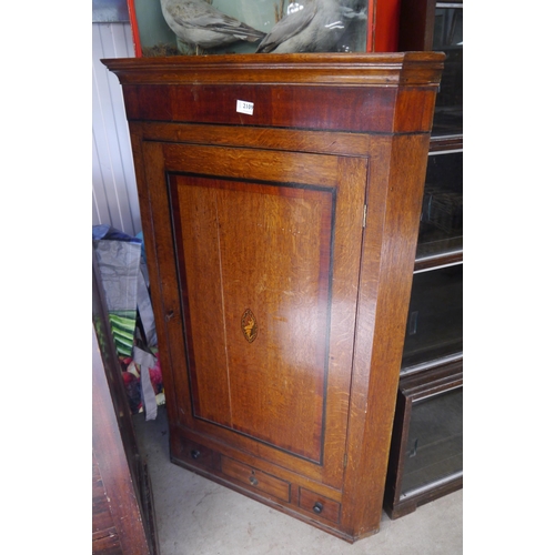 2109 - A Georgian oak and mahogany corner cupboard