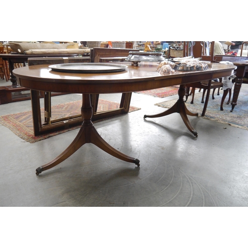 2250 - A Regency style mahogany twin pedestal dining table with extra leaf