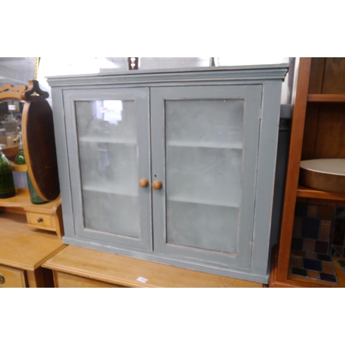 2321 - A painted pine glazed wall hanging unit