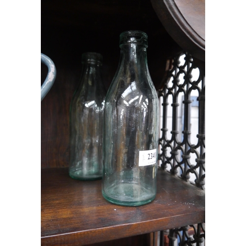 2341 - A pair of vintage milk bottles