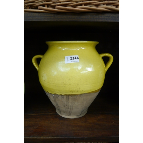 2344 - A yellow drip glazed twin handled stoneware pot