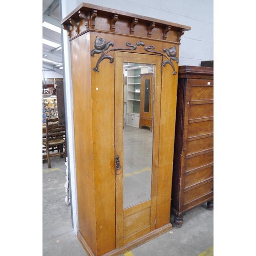 2354 - An Art Nouveau satinwood wardrobe with copper decorative front and mirror insert