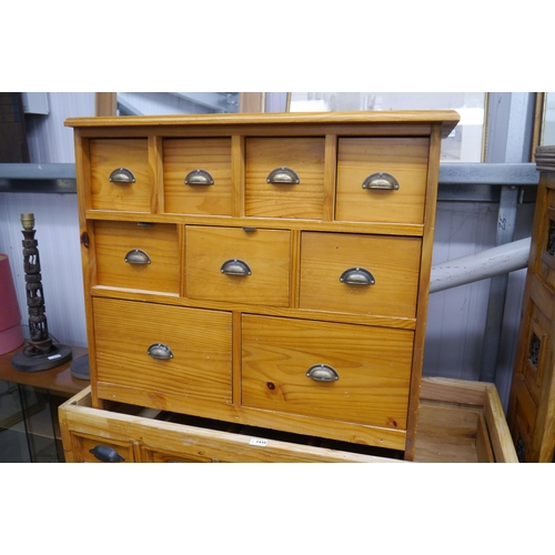 2431 - A modern pine chest of nine drawers, brass cup handles, one side top cut and a mirror