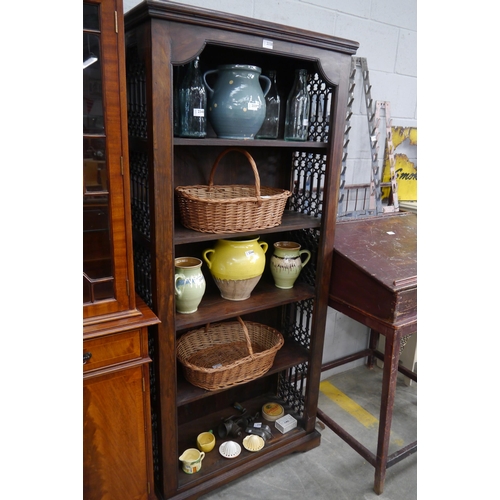 2338 - An Eastern hardwood bookcase with iron work sides