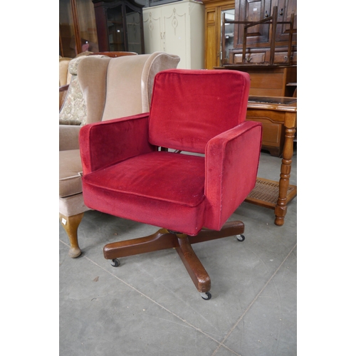 2370 - An 1940's red velvet swivel office chair