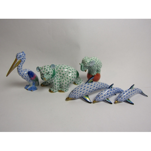 4335 - A collection of miniature Herend porcelain animals including three graduated dolphins, bear, elephan... 